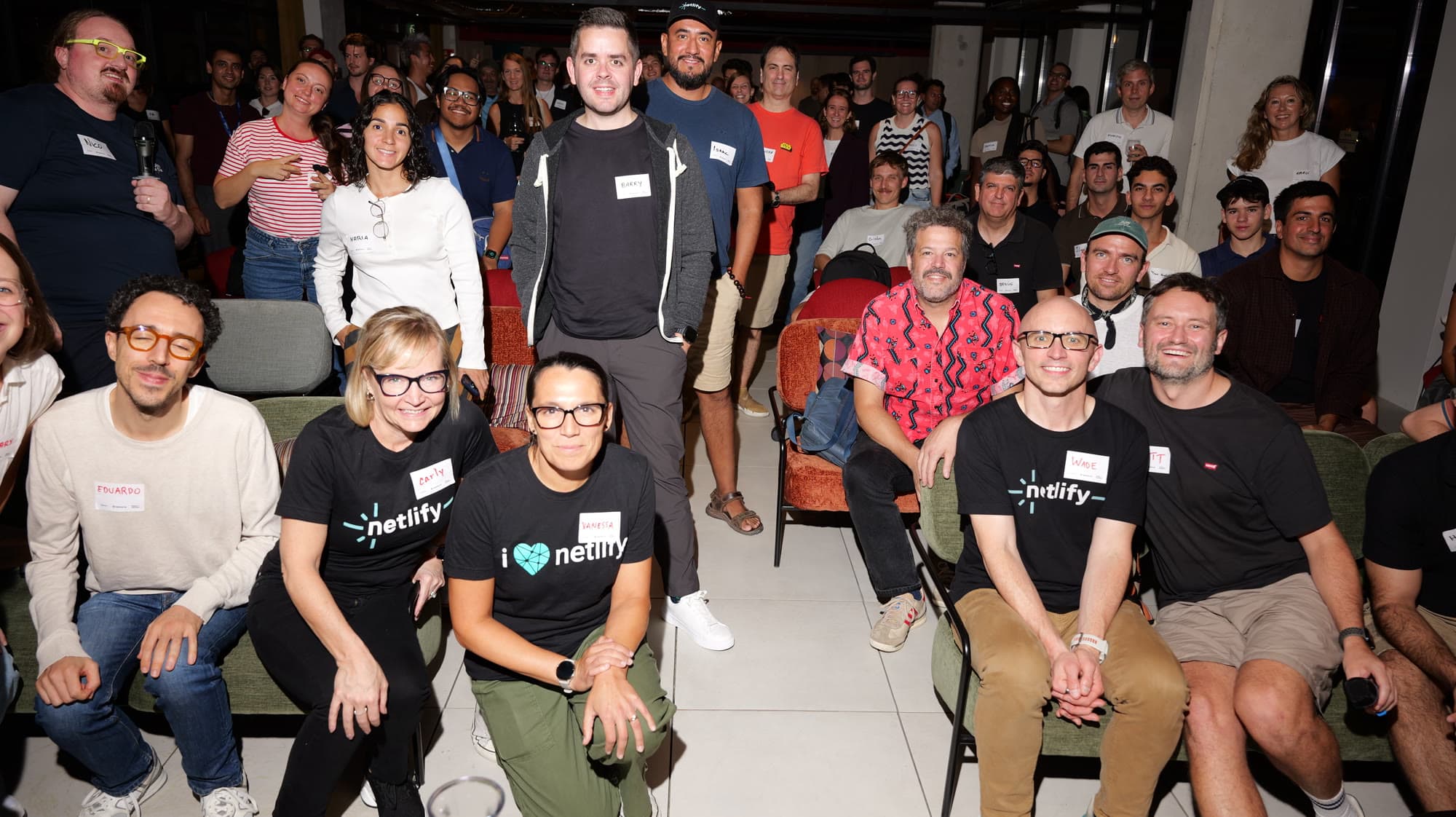 Attendees and the Netlify team posing together at the event
